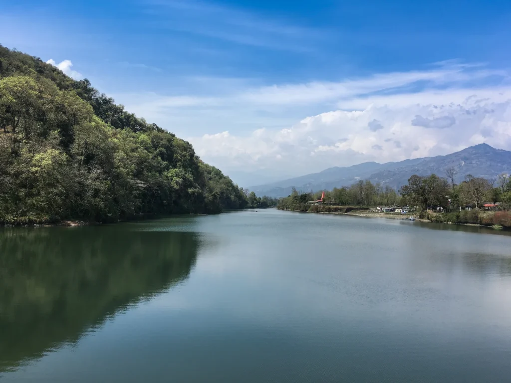 Phewa Lake beside forested slopes and the Lakeside shore.